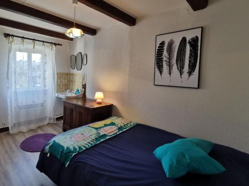 a bedroom with a bed and a sink in it at Gîte Mazeyrat-d'Allier, 4 pièces, 5 personnes - FR-1-582-200 in Mazeyrat-d'Allier