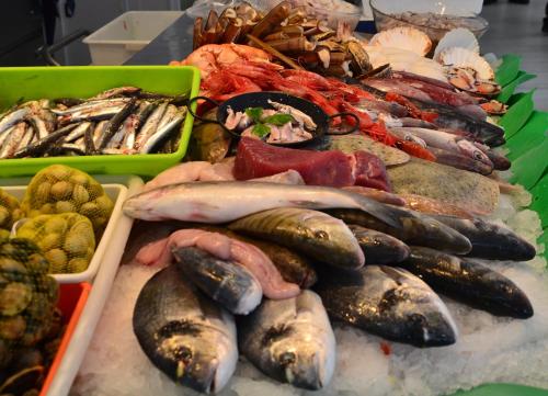 a table filled with different types of fish and seafood at Solvi Hotel - Adults Only in Vilanova i la Geltrú