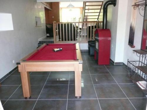 a ping pong table in the middle of a room at Gîte moderne avec billard et poêle à bois, proche de Mirecourt et Vittel, animaux bienvenus - FR-1-589-180 in Velotte-et-Tatignécourt