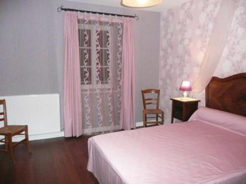 a bedroom with a bed and a window with pink curtains at Gîte moderne avec billard et poêle à bois, proche de Mirecourt et Vittel, animaux bienvenus - FR-1-589-180 in Velotte-et-Tatignécourt