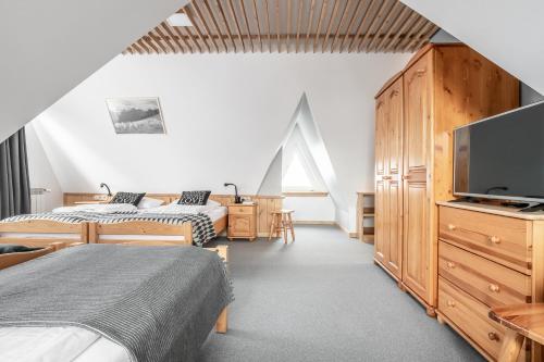 מיטה או מיטות בחדר ב-Willa Klimkówka