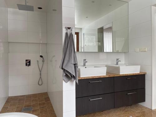 a bathroom with two sinks and a mirror at Apartament Krystynka nr 1 in Poronin