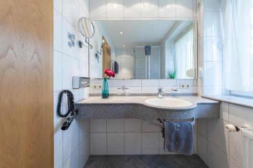 een badkamer met een wastafel en een spiegel bij Ferienhof Berger UG in Hagnau