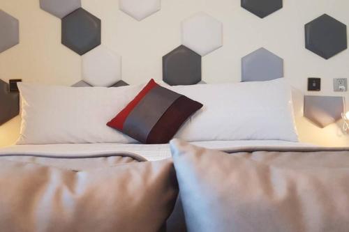 a bedroom with a bed with pillows on it at Modern Chic in Hengchun
