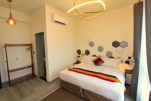 a bedroom with a large bed in a room at Modern Chic in Hengchun