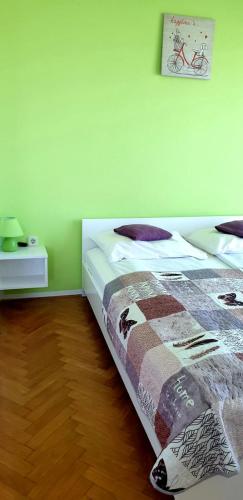 a bedroom with a bed with a blanket on it at IstraNova Apartments in Rovinj