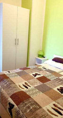a bedroom with a bed with a quilt on it at IstraNova Apartments in Rovinj