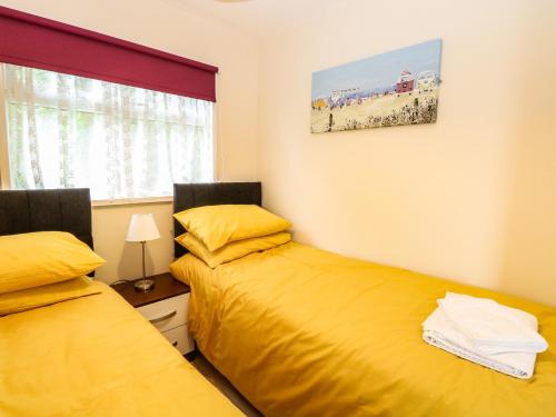 two beds sitting next to each other in a bedroom at Chalet 126a in Cromer