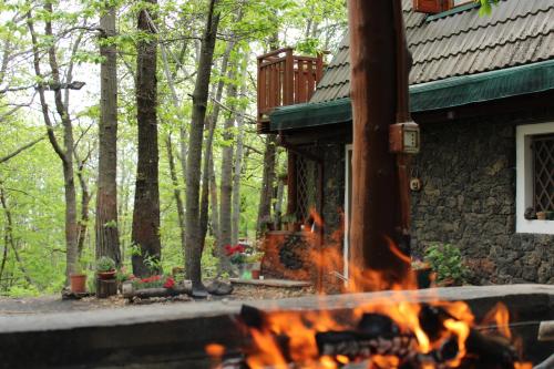 a fire burns in front of a house at Matilde's Chalet Etna Nature House in Nicolosi