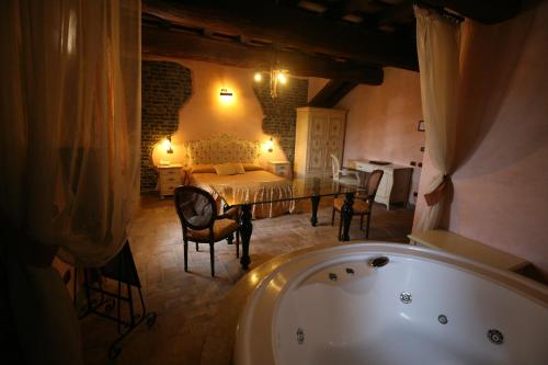 a bathroom with a tub and a bedroom with a bed at Relais Castrum Boccea in Boccea