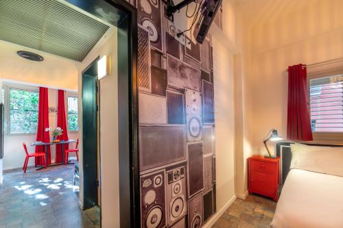 a room with a bedroom with a wall with a door at Ben Yehuda Apartments in Tel Aviv