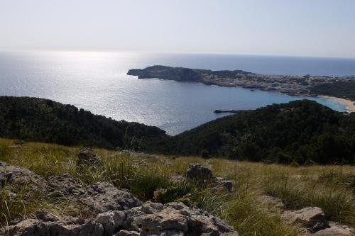 a view of a body of water from a hill at Bell Port Hotel in Cala Ratjada