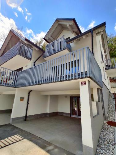 a building with balconies on top of it at Villa Recica North in Bled