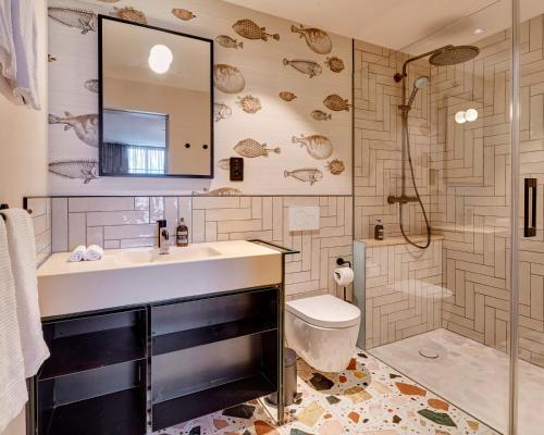 a bathroom with a sink and a toilet and a shower at Hotel Restaurant Seehof in Küssnacht