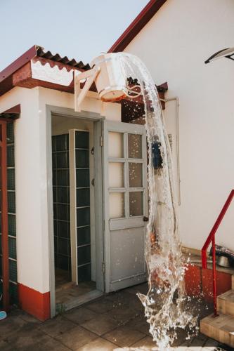 a house is being splashed with water at Guest House Lorem in Daugavpils