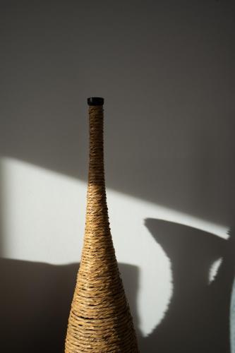 a close up of a vase with its shadow at La Ponta Villas & Suites in Akrotiri