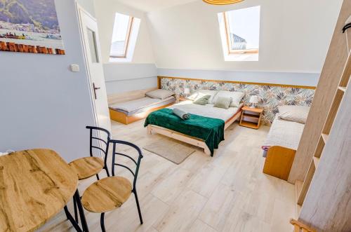 a bedroom with a bed and a table and chairs at Villa Baltic Karwia in Karwia