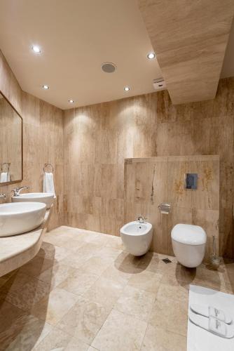 a bathroom with two sinks and two toilets at Hotel VEGA Sofia in Sofia