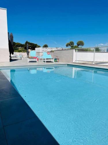 a large swimming pool with blue water at Lagrange Apart'Hôtel Antibes Olympie in Antibes