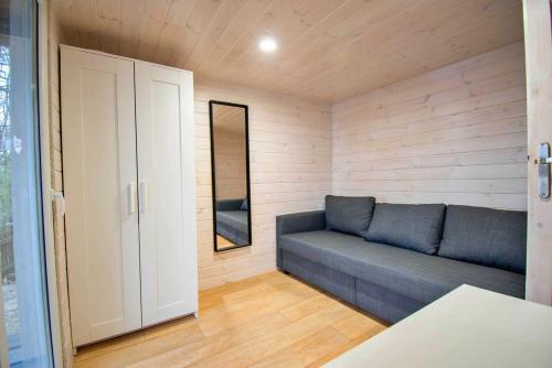 a living room with a couch in a room at Sielanka Mazury in Szczytno