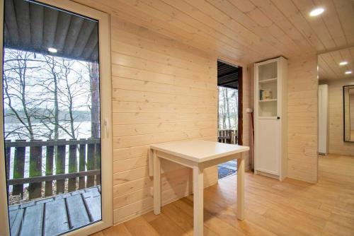 a small white table in a room with a balcony at Sielanka Mazury in Szczytno