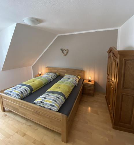 a bed with two pillows on it in a room at Ferienweingut Göbel in Traben-Trarbach