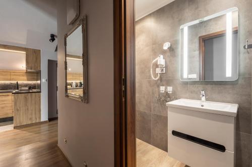 a bathroom with a sink and a mirror at Apartament Top Zakopane in Zakopane