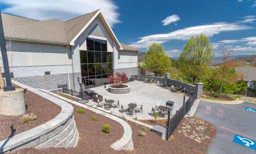 a building with a patio with tables and chairs at The Summit at Massanutten Resort by TripForth in McGaheysville