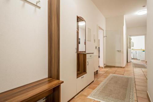 a hallway with white walls and a mirror at Apartment Tuna in Sigmarszell