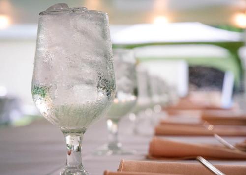 a row of wine glasses sitting on a table at Holiday Inn Express & Suites - St Peters by IHG in Saint Peters
