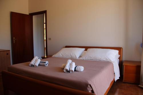 a bedroom with a bed with two towels on it at Appartamenti Pura Vida in Fano