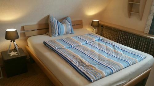 a bed with two pillows on it in a bedroom at Ferienhaus Stay and Relax in Korbach
