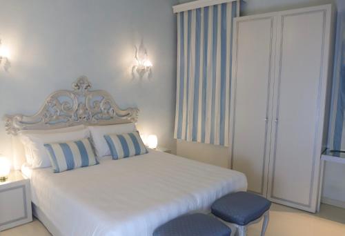 a bedroom with a white bed and a blue stool at Relais Venezia in Venice