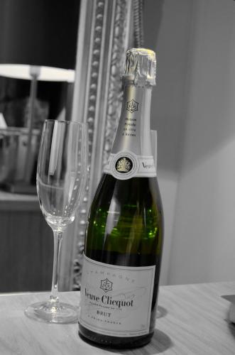 a bottle of wine sitting next to a wine glass at Quebecs Luxury Aparthotel in Leeds