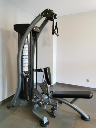 a gym with a treadmill and a bench at Hotel Port Toga in Bastia