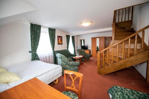 a hotel room with a bed and a staircase at ROMANTIK HOTEL ELEONORA in Tábor
