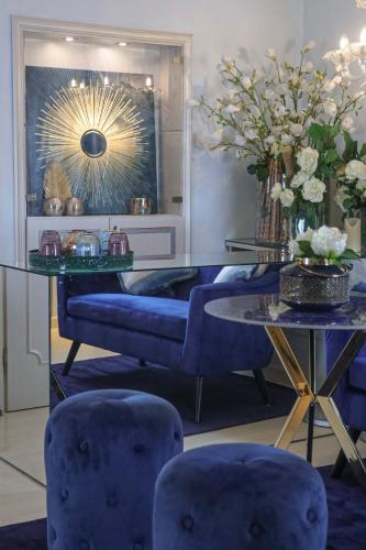 a room with blue chairs and a table with a mirror at Relais Venezia in Venice