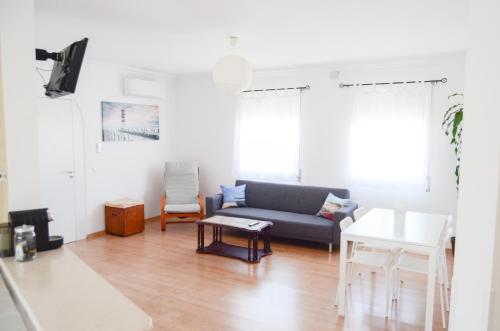 a living room with a couch and a table at BJB - Alojamentos in Olhão