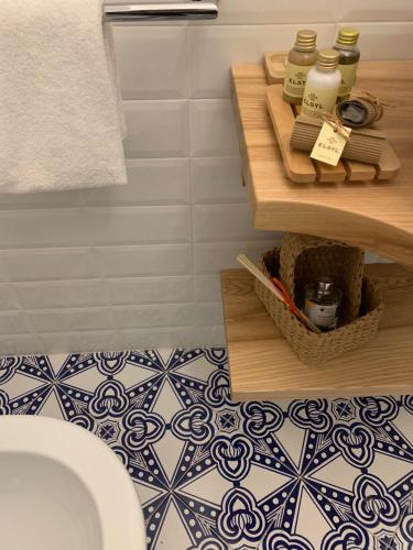 a bathroom with a sink and a toilet and a shelf at Villa Fortuna in Positano