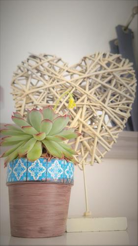 a plant in a pot in front of a heart sculpture at Prince Apartments in Fareham