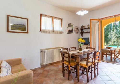 a living room with a table and chairs and a couch at Santa Margherita Vacanze in Poggibonsi