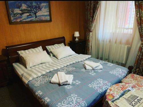 a bedroom with two beds with white pillows on them at Zakarpatska Kolyba in Odesa