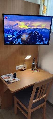a desk with a computer monitor on top of it at Brigel-Hof in Meßkirch