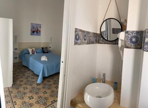 - une petite chambre avec un lit et un miroir dans l'établissement La casetta di Mavi, à Palerme