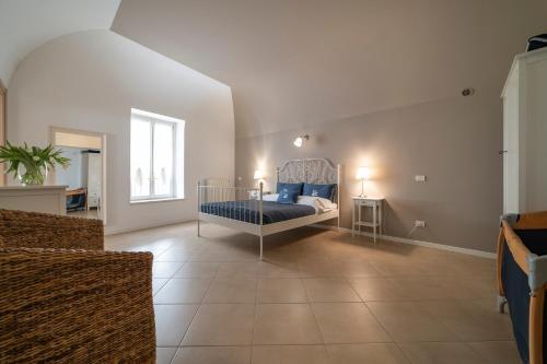 a bedroom with a bed in the middle of a room at Albergo Diffuso Vulcano Village in Castro