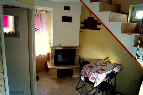 a living room with a table and a television and a staircase at Agroturystyka u Willima in Mechnica