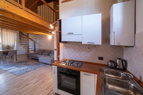 a kitchen with white cabinets and a stove top oven at Albergo Diffuso Vulcano Village in Castro