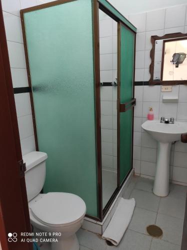 a bathroom with a shower and a toilet and a sink at Casas Vacacionales La Cima in Mérida