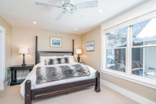 a bedroom with a bed with a ceiling fan and a window at Pacific West 431 in Telluride