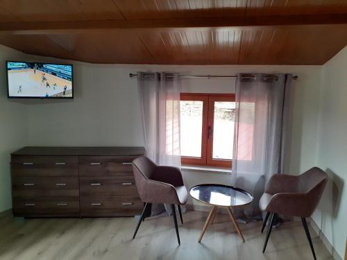 a room with two chairs and a table and a window at Casa Mota Pinto in Castro Daire